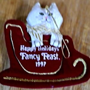1997 Fancy Feast Holiday Cat Ornament - White Cat on Red Sleigh